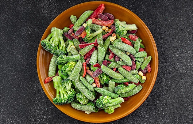 bowl filled with frozen snap peas, sliced red bell peppers, corn, broccoli, and beets